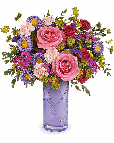 Brighten her Mother's Day with the Painted Petals Bouquet, a vibrant mix of pink and purple blooms artfully arranged in the Pretty Daydream Vase. This cheerful gift brings color, charm, and lasting beauty to her day.

The Painted Petals Bouquet features pink roses, hot pink spray roses, miniature pink carnations, dark pink sweet william, lavender Matsumoto asters, and purple sinuata statice, accented with bupleurum and parvifolia eucalyptus, delivered in the Pretty Daydream Vase.